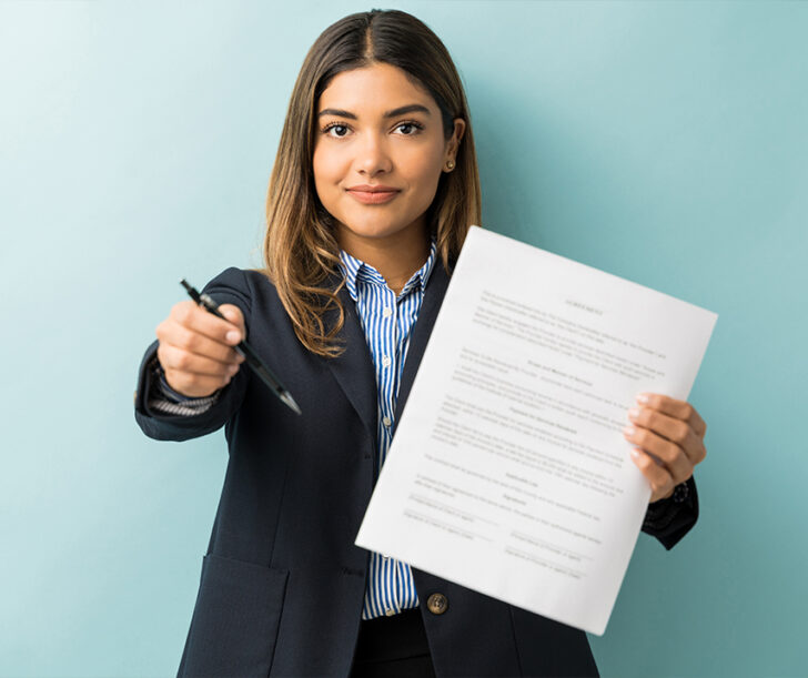 confident-young-female-professional-with-contract-pen-against-colored-background confident-young-female-professional-with-contract-pen-against-colored-background